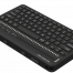 Photo showing an angled perspective view of the Orbit Reader Q40 Refreshable 40-cell Braille Display with an integrated QWERTY keyboard. Shows the words "Orbit Reader Q40" in braille on the braille display. The picture shows the QWERTY keyboard on top of the unit, along with cursor routing buttons. On the front of the unit are 4 thumb keys for navigation and the left side of the unit.