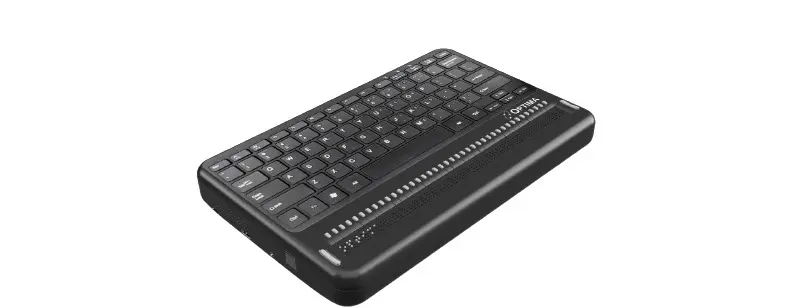 Photo showing angled view of the Optima Braille Laptop Computer with braille display and cursor rounting on top with QWERTY keyboard and on right side you will see USB port